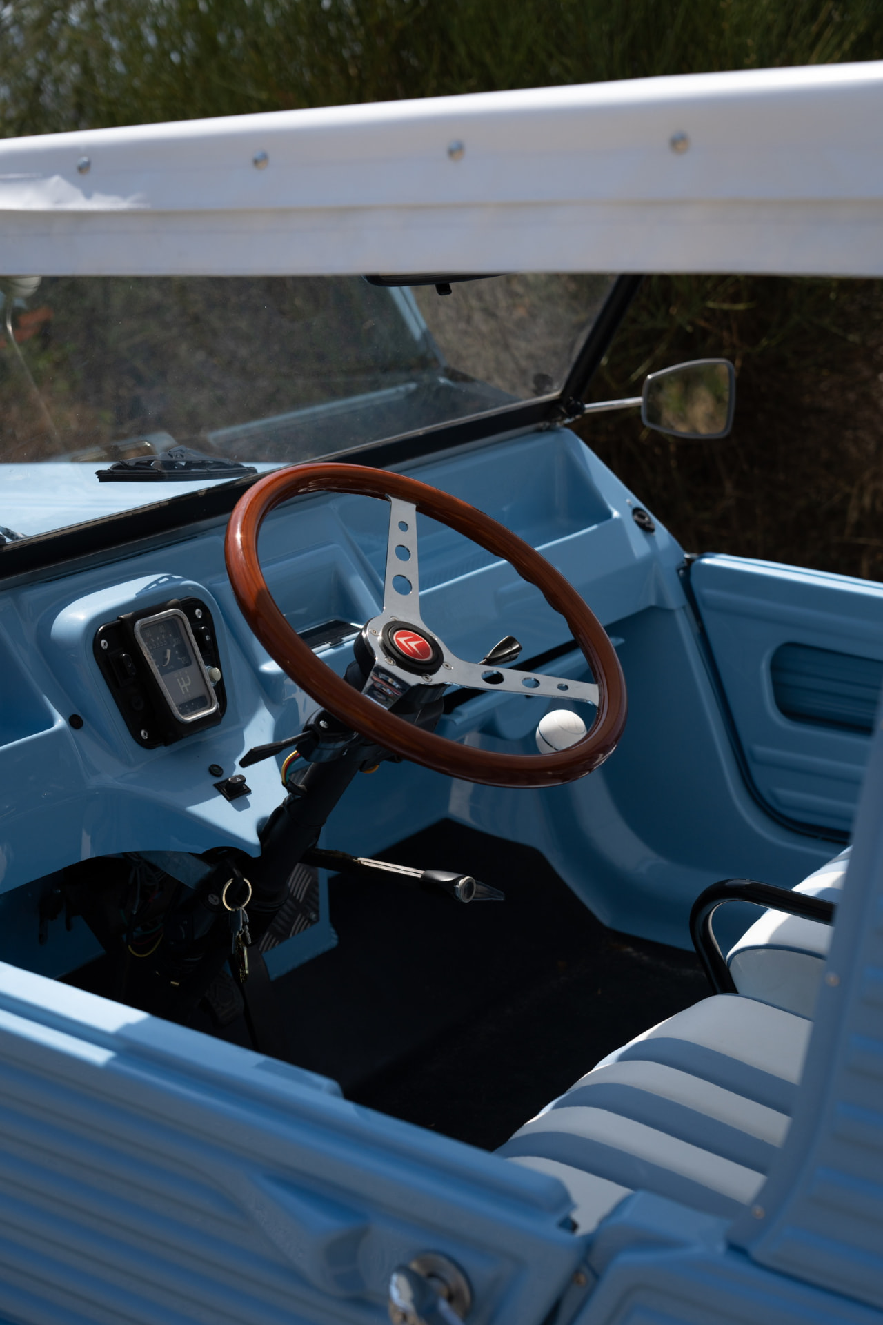 Blue Citroën Méhari interior with wooden steering wheel